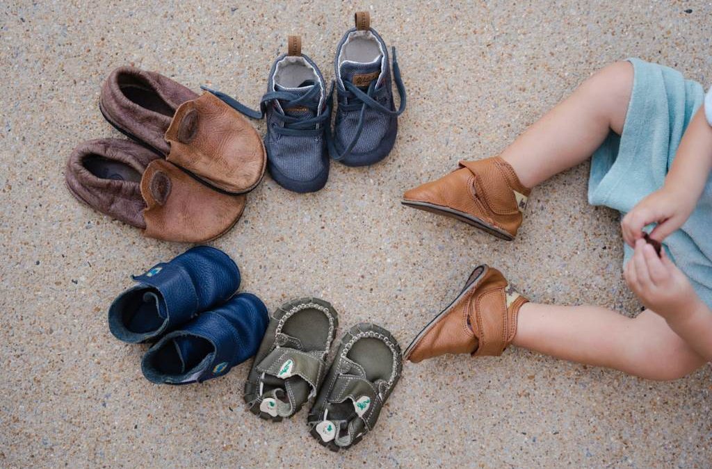 Adorable baby feet in spacious wide toe box shoes promoting natural growth.