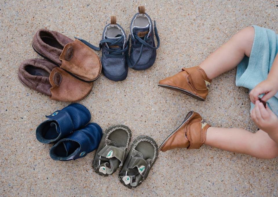 Adorable baby feet in spacious wide toe box shoes promoting natural growth.