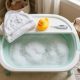 Foldable compact baby bathtub stored vertically inside small bathroom