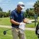 Florida golfer drying club grips with a microfiber golf towel on a sunny, humid course in 2026