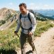 Man hiking on a sunny trail wearing a protective sun shirt.